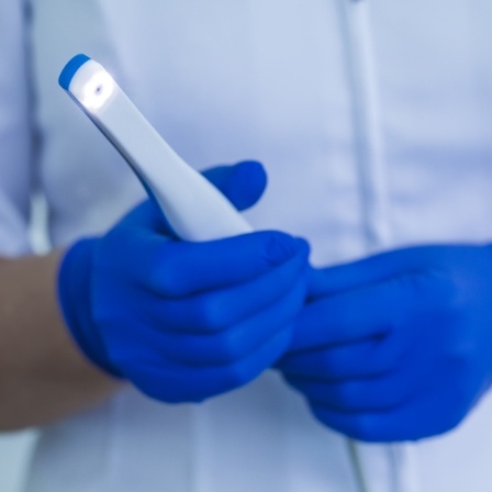 Dental professional holding an intraoral camera