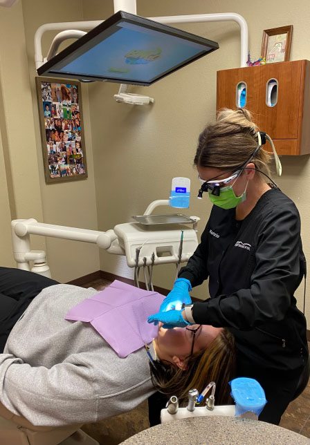 Dental team member treating a patient